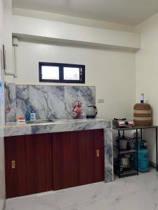 a kitchen with a counter top and a window at Baldonado Transient Homestay in San Isidro