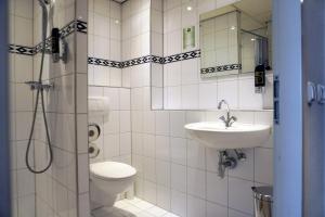 a bathroom with a toilet and a sink and a shower at Westlake Hotels Amsterdam in Amsterdam +47 photos