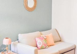 a white couch with pillows on it in a room at L'escale - proche Homme de Fer in Strasbourg