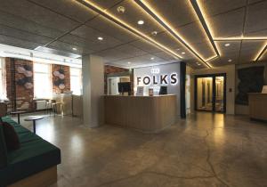 a lobby with a floks sign in a building at The Folks Hotel Konepaja in Helsinki