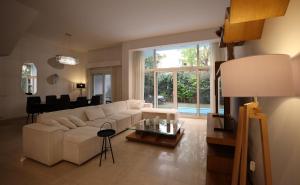 a living room with a white couch and a table at Luxury 4BR New Cairo Villa with Pool & Stylish Living - FAMILY ONLY in Cairo