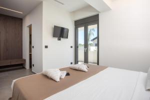 a bedroom with a large bed with two pillows on it at Casadi Luxury Villa in Ialysos +92 photos