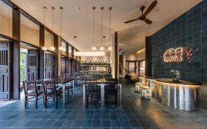 a restaurant with tables and chairs and a ceiling at Heritage Gem Boutique Villa in Hoi An