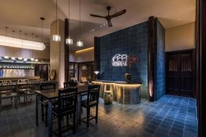 a restaurant with tables and chairs and a bar at Heritage Gem Boutique Villa in Hoi An