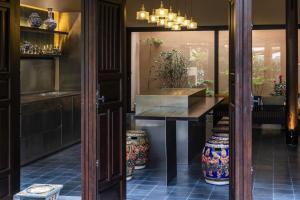 a dining room with a table and a window at Heritage Gem Boutique Villa in Hoi An