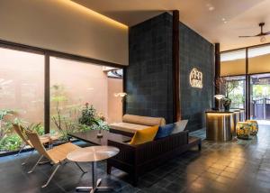 a living room with a couch and a table at Heritage Gem Boutique Villa in Hoi An +42 photos