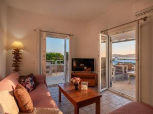 a living room with a couch and a table at Angel Serenity Villa in Kampos Paros