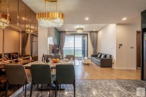 a living room and dining room with a table and chairs at Lumière Royal Sky Residence in Ho Chi Minh City