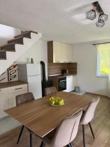 a kitchen with a table with a bowl of fruit on it at Vikendica Markić in Šipovo