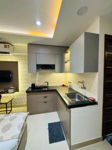 a kitchen with a sink and a counter top at Candlewick Homestays in Jaipur
