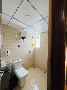 a bathroom with a toilet and a sink at Candlewick Homestays in Jaipur