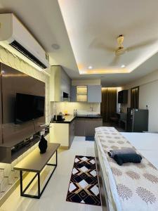 a large room with a large bed and a kitchen at Candlewick Homestays in Jaipur