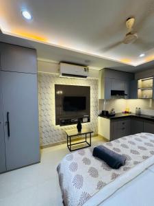 a bedroom with a large bed and a television at Candlewick Homestays in Jaipur
