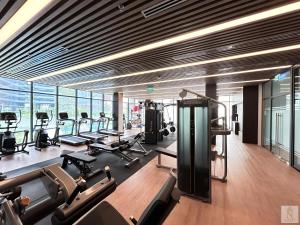 a gym with treadmills and exercise equipment in a building at Lumière Royal Sky Residence in Ho Chi Minh City