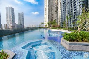 a swimming pool in the middle of a city with tall buildings at Lumière Royal Sky Residence in Ho Chi Minh City +129 photos