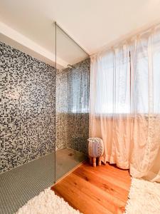 a room with a glass shower with a curtain at Evasion Alpine in Crans-Montana