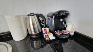 a coffee maker on a counter next to a roll of paper towels at White Tower Mamaia Beach 505 in Mamaia +27 photos