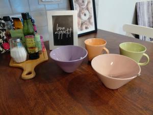 a wooden table with bowls and bottles on it at Koivukuja Apartment in Vuokatti