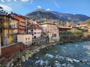 a group of buildings next to a river at Villa Coccodrilla Varallese in Varallo