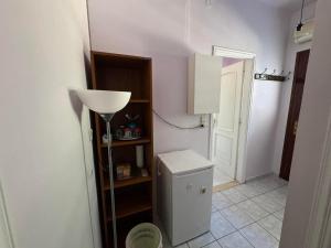 a bathroom with a refrigerator and a room with a door at Christina's Apartments in Vathi +10 photos