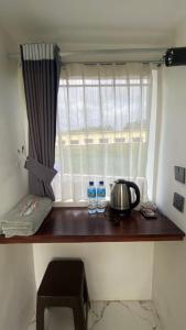 a table with two bottles of water and a window at Villa Miradarma in Sembalun Lawang
