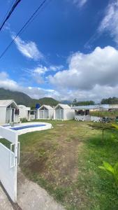 a view of a yard with a row of houses at Villa Miradarma in Sembalun Lawang +22 photos