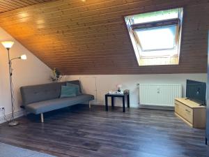 a living room with a couch and a window at Wesernest Schulz in Höxter