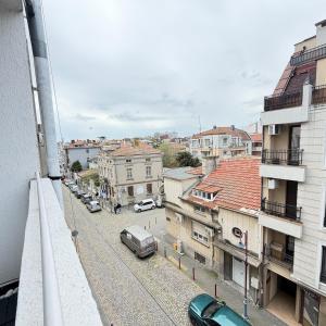 a view of a city with cars parked on a street at Cool Downtown Apartment in Burgas