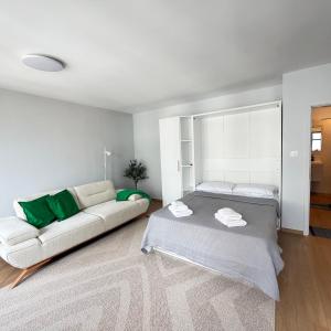 a living room with a bed and a couch at Cool Downtown Apartment in Burgas