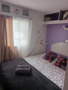 a bedroom with a bed with a towel on it at Mobil home zen élégant in Mimizan +19 photos