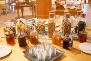 a wooden table with jars of food and condiments at Hotel Villa Gustui Maris in Cala Gonone