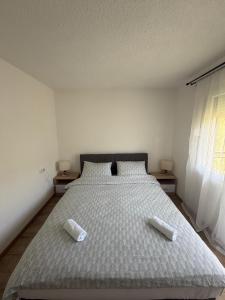 a bedroom with a bed with two pillows on it at Vikendica Markić in Šipovo