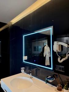 a bathroom with a sink and a mirror at Esbjerg Hotel in Vlorë +94 photos