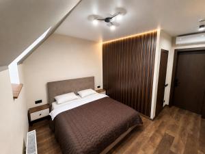 a bedroom with a bed and a ceiling fan at Prime Hotel in Dnipro
