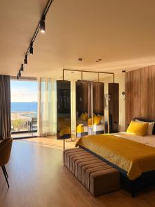 a bedroom with a large bed and a view of the ocean at Esbjerg Hotel in Vlorë