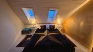 a attic room with a bed with a star on it at AjoieSpa in Porrentruy