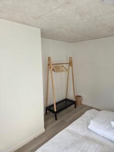 a room with a bed and a ladder in the corner at Harknakvej 19BB in Bredebro