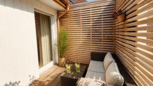 a patio with a couch and a window at AjoieSpa in Porrentruy +15 photos