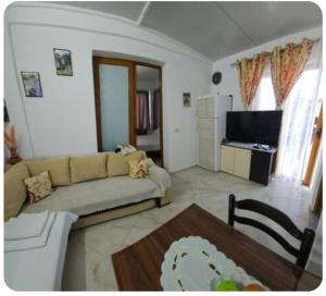 a living room with a couch and a table at Villa Kena in Ksamil