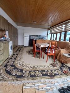 a living room with a table and a couch at Moy Dom in İsmayıllı