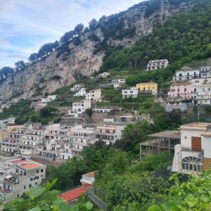 a group of buildings on a hill with a mountain at Tenuta Rispoli Pogerola in Amalfi