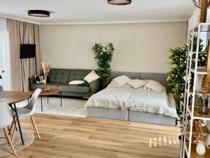 a bedroom with a bed and a couch and a table at Ateliér Smutná in Ostrava