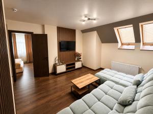 a living room with a couch and a television at Prime Hotel in Dnipro +32 photos