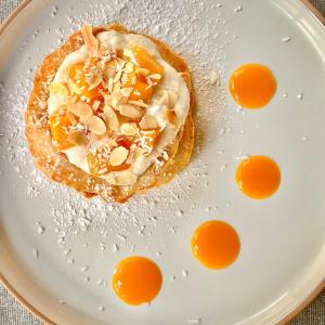 a pastry on a plate with eggs on it at Crafnant House - Bed & Breakfast in Trefriw
