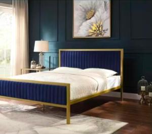 a bedroom with a bed with a blue wall at Richmond Hill Guest House in Port Elizabeth