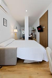 a bedroom with a large white bed in a room at Pato - Modern Apt - Near Bioparc by Río Turia Apartments in Valencia
