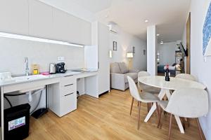 a kitchen and living room with a table and chairs at Pato - Modern Apt - Near Bioparc by Río Turia Apartments in Valencia