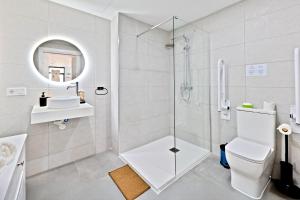 a bathroom with a shower and a toilet and a sink at Pato - Modern Apt - Near Bioparc by Río Turia Apartments in Valencia +14 photos