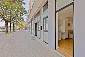 a building with large windows on a street at Pato - Modern Apt - Near Bioparc by Río Turia Apartments in Valencia