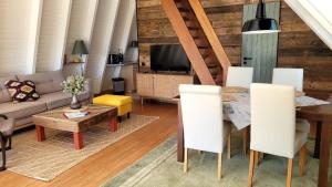 a living room with a couch and a table at Chalet in Freilingen Blankenheim mit Seenähe mitten in der Natur in Blankenheim